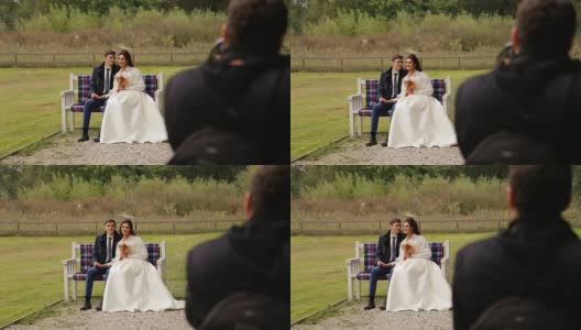 一对新婚夫妇在长凳上对着摄影师摆姿势高清在线视频素材下载