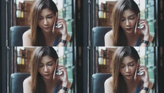 可悲的亚洲女人用手机和男友分手高清在线视频素材下载