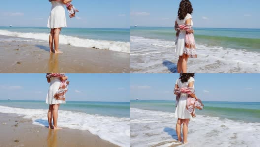 美丽的年轻女子独自站在空旷的海滩上，慢镜头高清在线视频素材下载