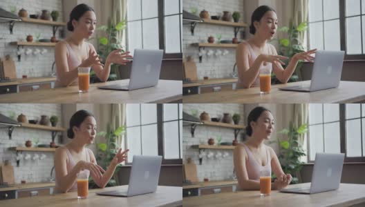 一位健康的亚洲女性微笑着在笔记本电脑上进行视频通话高清在线视频素材下载