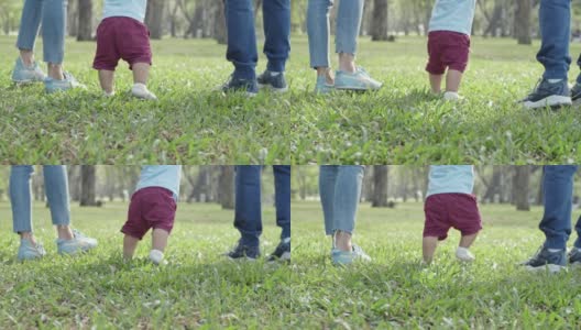 父母牵着儿子的手在公园散步高清在线视频素材下载
