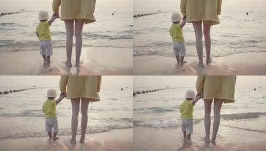 妈妈和孩子站在海滩上高清在线视频素材下载