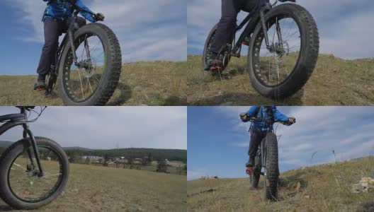 胖自行车或胖轮胎的自行车在夏天开车穿过山丘。高清在线视频素材下载