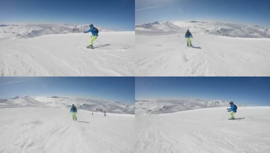在阳光明媚的冬日，高山滑雪者在滑雪场滑雪高清在线视频素材下载