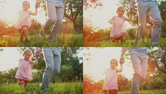 小女孩牵着父亲的手穿过阳光灿烂的果园高清在线视频素材下载