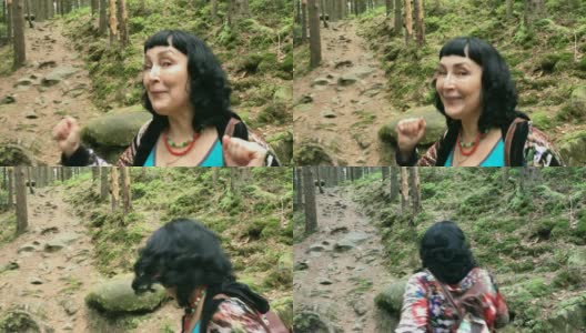一个快乐的成年女人爬上了山中的一条森林小径。高清在线视频素材下载