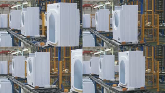 白色洗衣机机体在工业工厂的生产输送机上移动高清在线视频素材下载