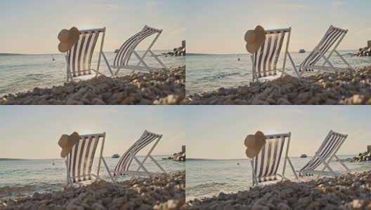 日落时分，沙滩上的两把沙滩椅高清在线视频素材下载