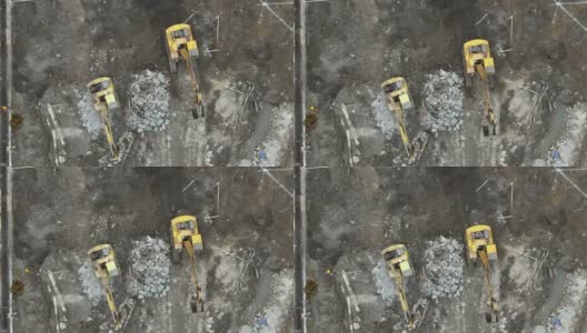 地面上建筑工地的工人和挖掘机的无人机鸟瞰图高清在线视频素材下载