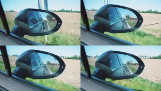 一辆在路上行驶的汽车的近距离后视镜。高清在线视频素材下载