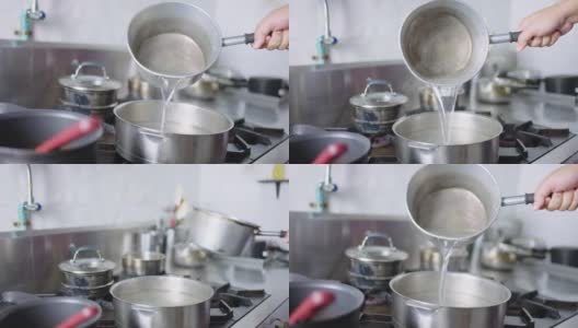 SLO MO:厨师用手将热水倒入锅中。高清在线视频素材下载
