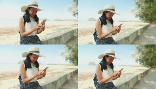 周末度假，亚洲美女在海边用智能手机拍照。快乐单人旅行的概念。高清在线视频素材下载