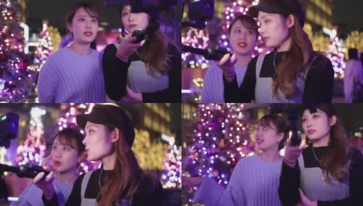 年轻的女性朋友在圣诞节的灯光下自拍电影高清在线视频素材下载