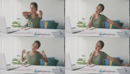 亚洲商业女性伸展身体放松，而工作的笔记本电脑在客厅在家里。高清在线视频素材下载