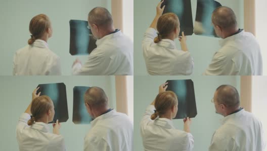 男性和女性医生检查x射线图像高清在线视频素材下载