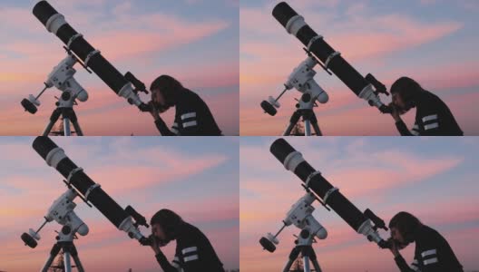 一个小女孩的剪影，望远镜在繁星点点的天空下。高清在线视频素材下载