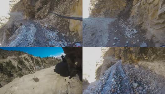一个骑摩托车的人在一条危险的山路上行驶高清在线视频素材下载