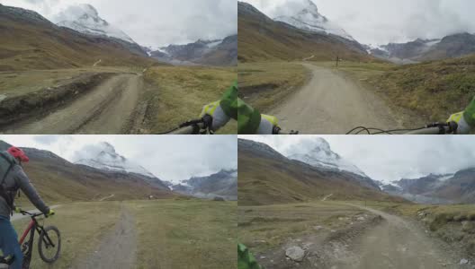 骑山地自行车的人沿着远处标志性的山下山高清在线视频素材下载
