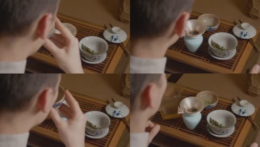 茶师将清水杯倒入碗中，饮用中国茶高清在线视频素材下载