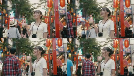 台湾千禧女喝着珍珠奶茶走在西门町购物区(慢镜头)高清在线视频素材下载