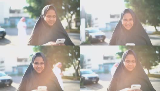 阿拉伯中东妇女在街上使用智能手机的肖像高清在线视频素材下载