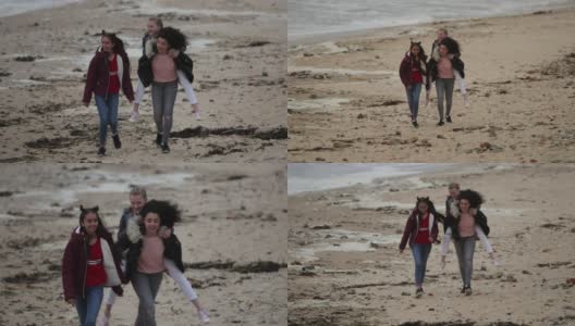 在Windy Beach上给朋友背背的女孩高清在线视频素材下载