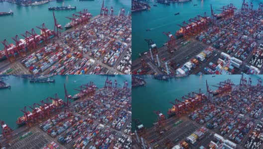 集装箱货轮在进出口业务和物流国际货物中的航拍折叠。由起重机在香港维多利亚港的晚上运往港口。高清在线视频素材下载