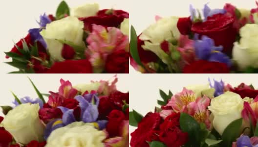 美丽的玫瑰花束，蝴蝶花和紫花快速旋转高清在线视频素材下载