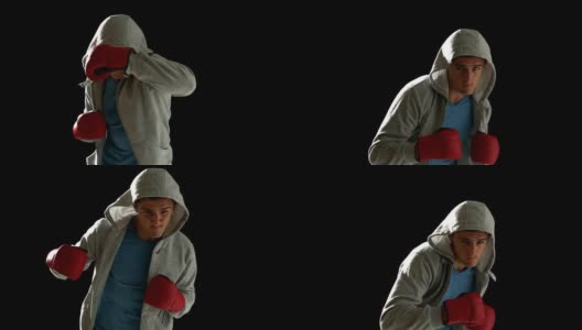 Fit man出拳与拳击手套在黑色的背景高清在线视频素材下载