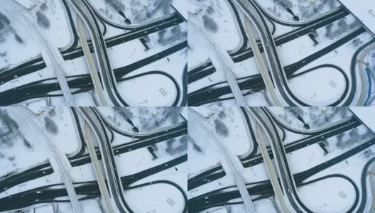 鸟瞰图高速公路交叉口在冬天被雪覆盖。高清在线视频素材下载