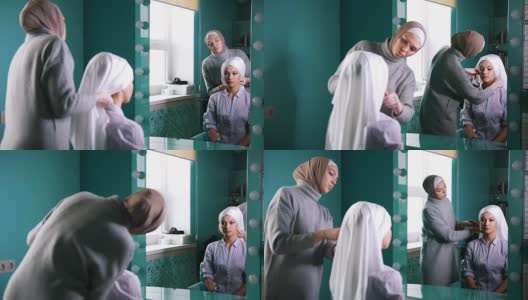 两名穆斯林妇女系上伊斯兰头巾，准备近镜举行婚礼高清在线视频素材下载