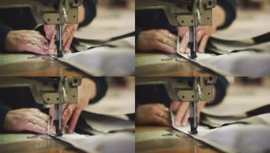 一个白人妇女的手引导一个工业缝纫机的压脚在室内制造设施缝织物高清在线视频素材下载