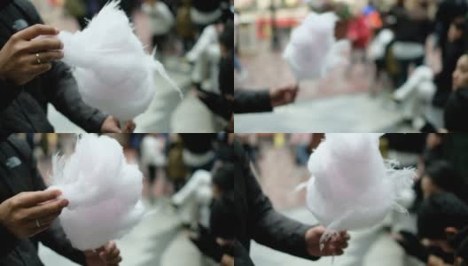 一个人在游乐园卷起来吃白色棉花糖高清在线视频素材下载