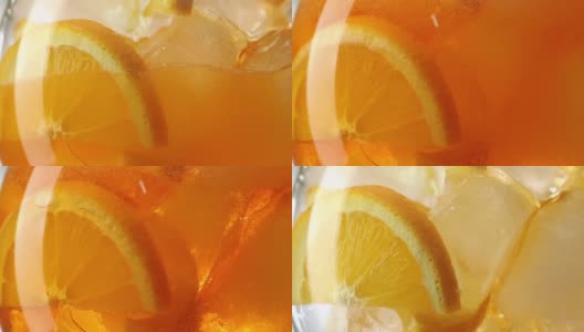 气泡饮料倒进装有橘子片和冰块的玻璃杯中，特写慢镜头高清在线视频素材下载