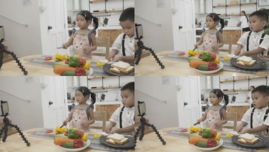 亚洲孩子在做饭和直播。高清在线视频素材下载