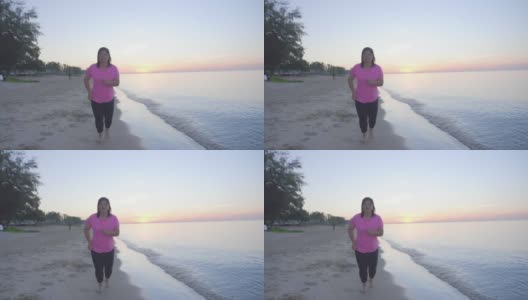 暑假里，亚洲胖女人早上在沙滩上慢跑高清在线视频素材下载