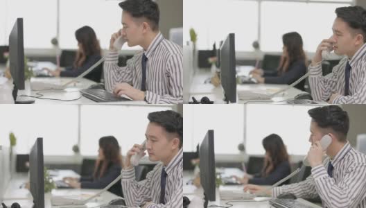 亚洲男子电话营销操作员戴着耳机与团队工作在呼叫中心城市办公室高清在线视频素材下载