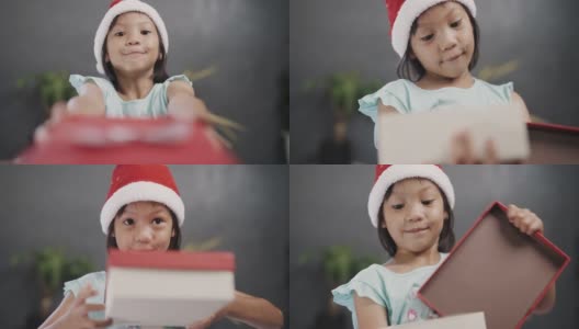 戴圣诞帽的女孩打开礼盒。高清在线视频素材下载