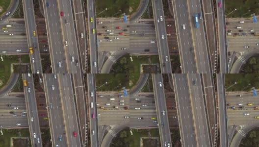 高速公路交叉口鸟瞰图与繁忙的城市交通在道路上超速行驶。跨越式运输桥梁高清在线视频素材下载