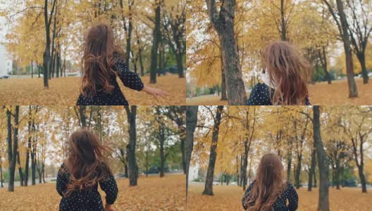 后视图快乐可爱的小女孩卷着头发穿过秋天的小巷在公园慢莫高清在线视频素材下载