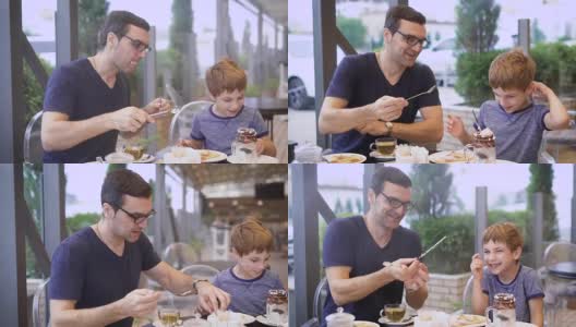 一位年轻的父亲尝试他儿子的牛奶鸡尾酒与冰淇淋和巧克力，儿子笑了，一家人正在餐厅用餐高清在线视频素材下载