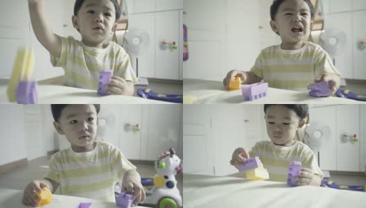 亚洲婴儿玩彩色塑料砖高清在线视频素材下载