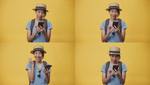 快乐青春美丽亚洲女人戴着帽子和背包持有智能手机享受预订旅行旅行酒店和机票书。高清在线视频素材下载