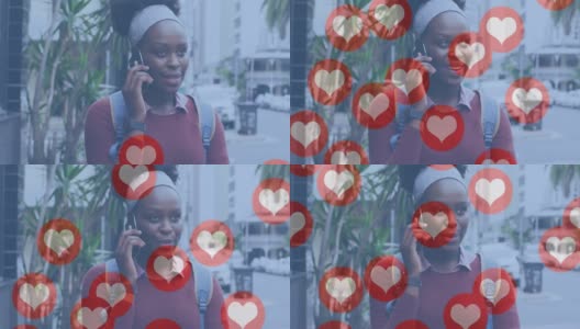 在大街上使用智能手机的微笑的非裔美国妇女的社交媒体心形图标的动画高清在线视频素材下载