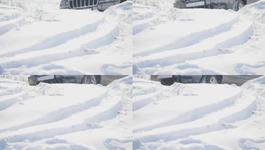 带有雪地车轮和冬季轮胎的Suv在雪地上行驶，近景高清在线视频素材下载