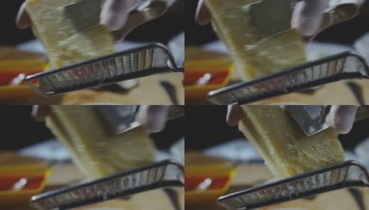 一个厨师磨碎的帕玛森奶酪，典型的意大利奶酪，在盘子里刚刚酿造。高清在线视频素材下载
