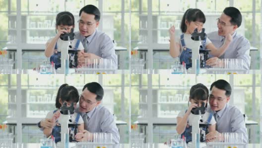 亚洲小孩和老师在学校实验室用显微镜观察。小女孩用显微镜学习科学课。教育的主题高清在线视频素材下载