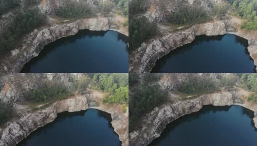 闭坑黑湖，周围有大悬崖峭壁。拍摄与无人机高清在线视频素材下载