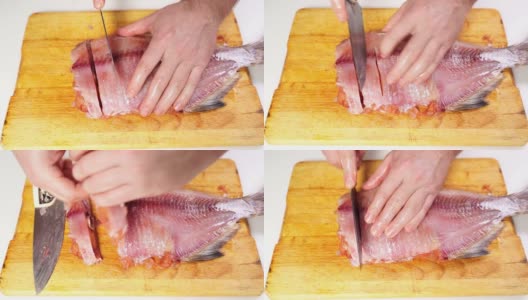 用手把去皮的咸鱼干切成片放在木板上。高清在线视频素材下载