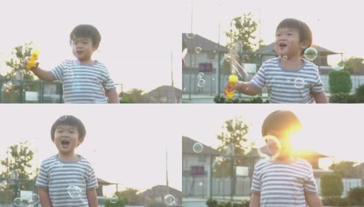 亚洲小男孩在公园里玩肥皂泡高清在线视频素材下载